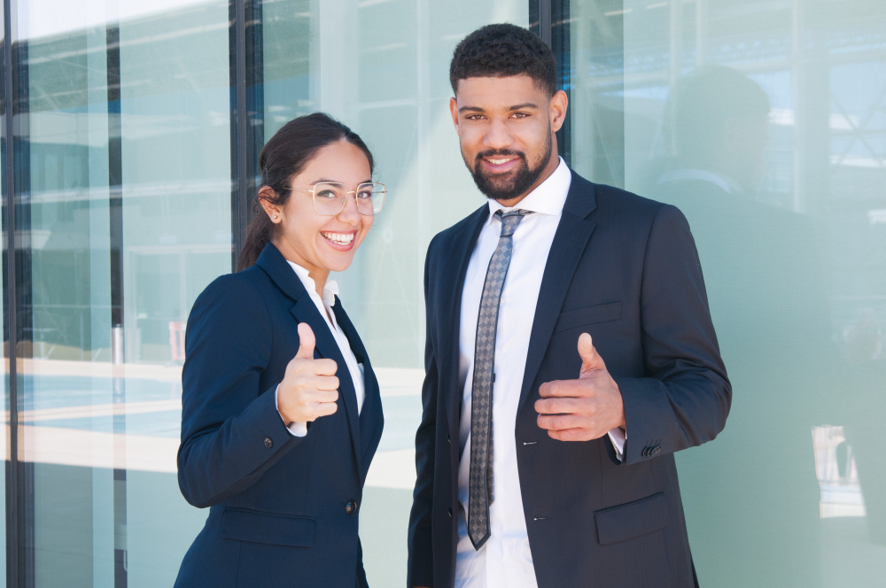 Smiling professionals giving thumbs up, representing M&A advisors launching their own exit advisory businesses with Ventariom platform.